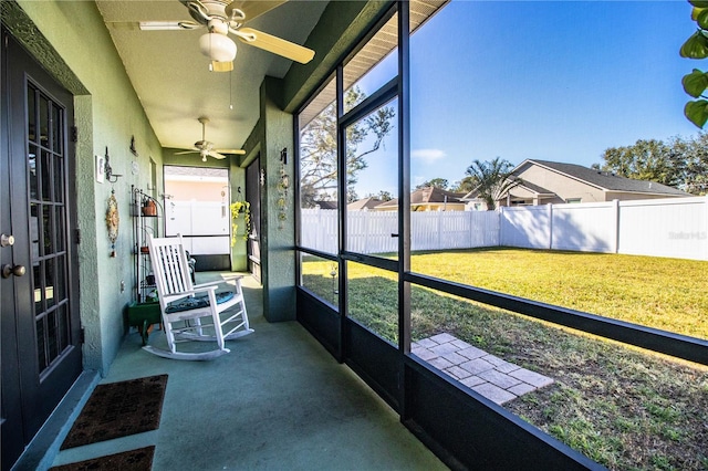 unfurnished sunroom with a wealth of natural light and ceiling fan