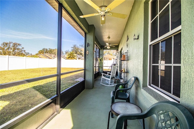 sunroom / solarium featuring ceiling fan and a healthy amount of sunlight