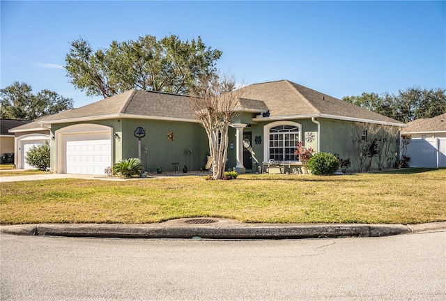 ranch-style house featuring a garage and a front yard