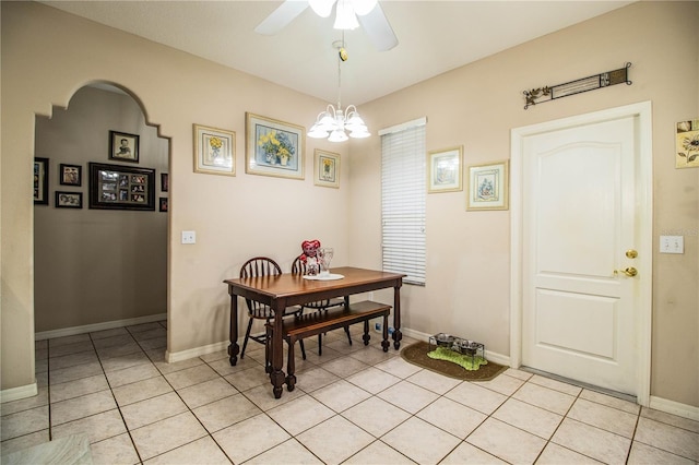 dining area with ceiling fan with notable chandelier and light tile patterned flooring