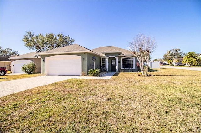 ranch-style house featuring a garage and a front lawn