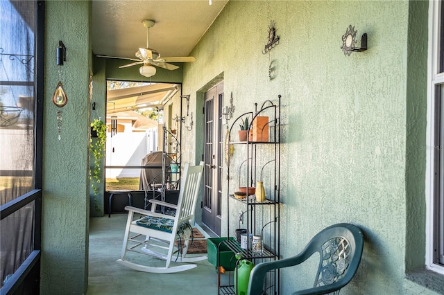 sunroom / solarium featuring ceiling fan