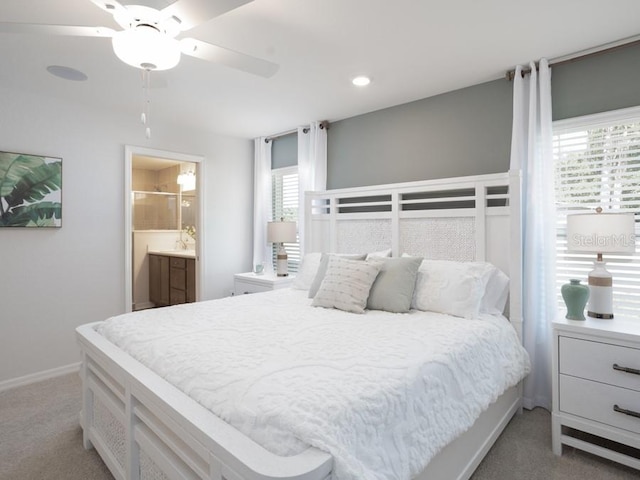 carpeted bedroom featuring ceiling fan and ensuite bathroom