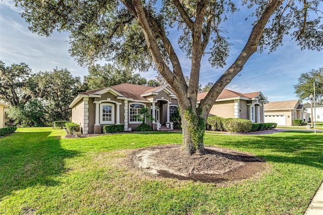 ranch-style home with a garage and a front lawn