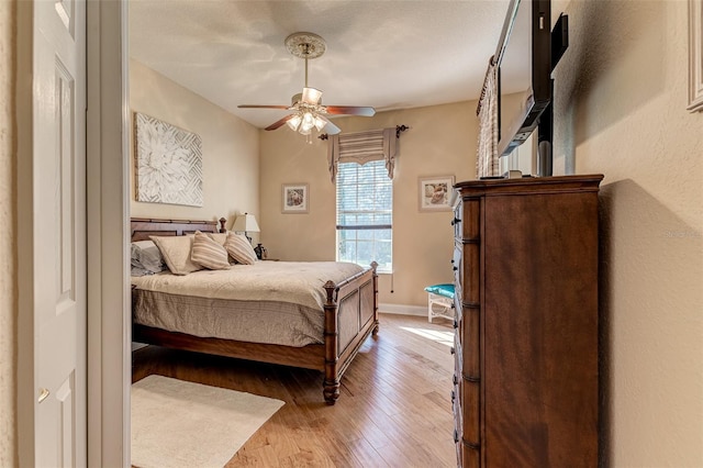 bedroom with ceiling fan and light hardwood / wood-style floors