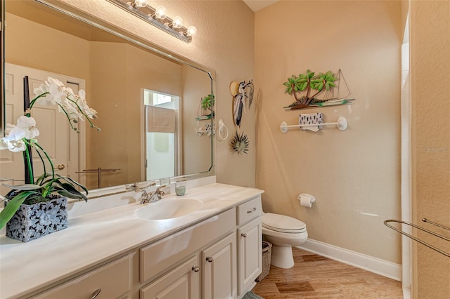 bathroom featuring vanity, hardwood / wood-style floors, and toilet