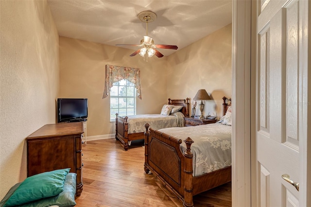 bedroom with hardwood / wood-style flooring and ceiling fan