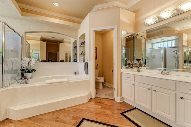 full bathroom featuring vanity, crown molding, plus walk in shower, and toilet