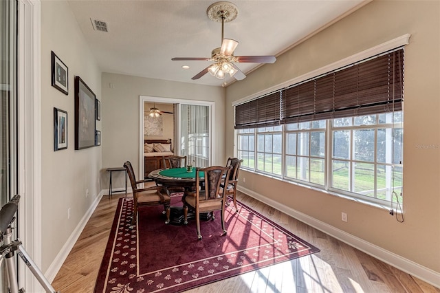 dining area with hardwood / wood-style flooring and ceiling fan