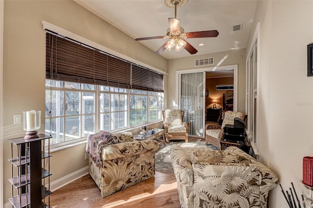 sunroom / solarium featuring ceiling fan