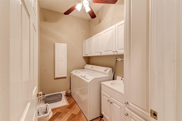 washroom featuring separate washer and dryer, light hardwood / wood-style floors, cabinets, and ceiling fan