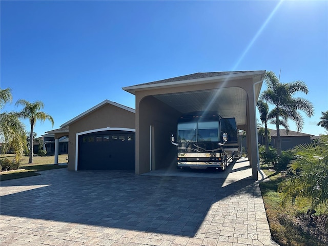 view of front of house with a garage and a carport