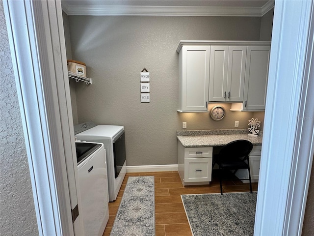 washroom featuring crown molding, cabinets, and washing machine and dryer