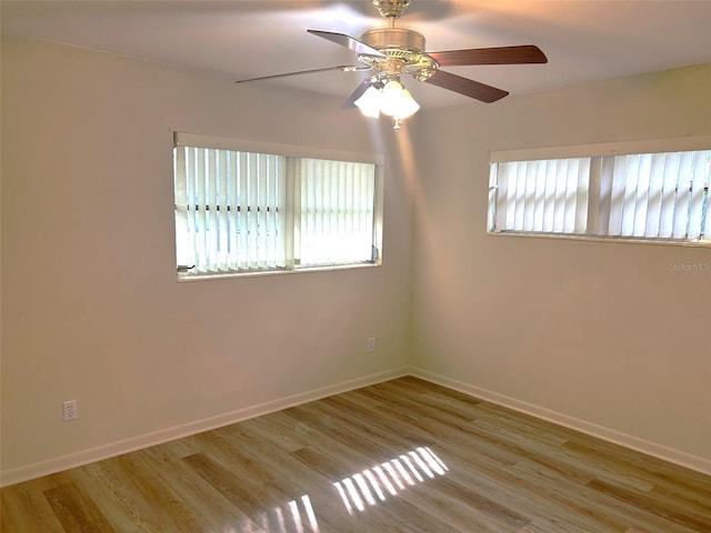 spare room featuring light hardwood / wood-style floors and ceiling fan