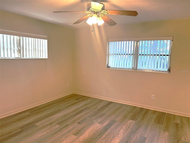 spare room with hardwood / wood-style floors and ceiling fan