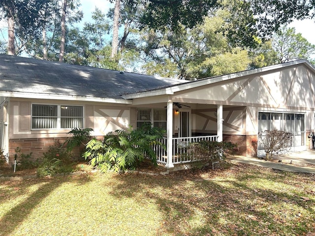 view of front of home with a front yard, ceiling fan, and a porch