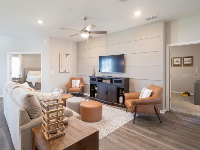 living room featuring hardwood / wood-style floors and ceiling fan