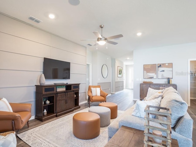 living room with wood-type flooring and ceiling fan