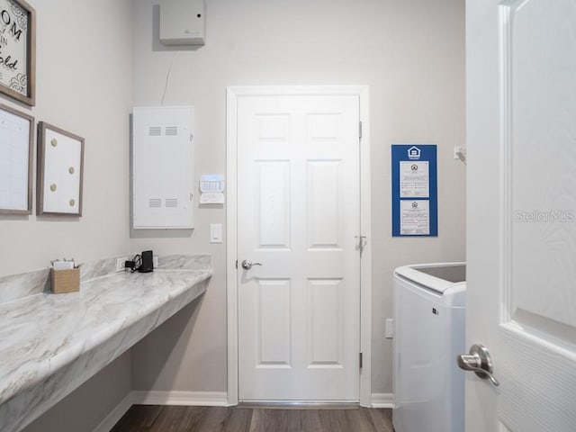 bathroom featuring wood-type flooring and washer / dryer