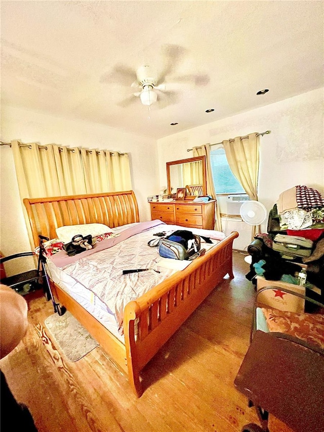 bedroom featuring ceiling fan and hardwood / wood-style floors