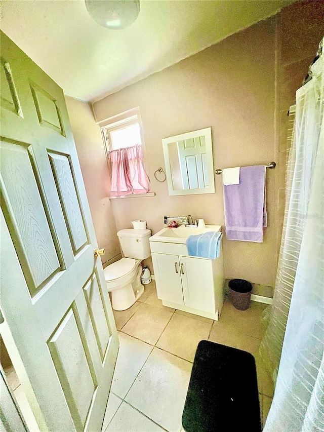 bathroom with vanity, tile patterned floors, and toilet