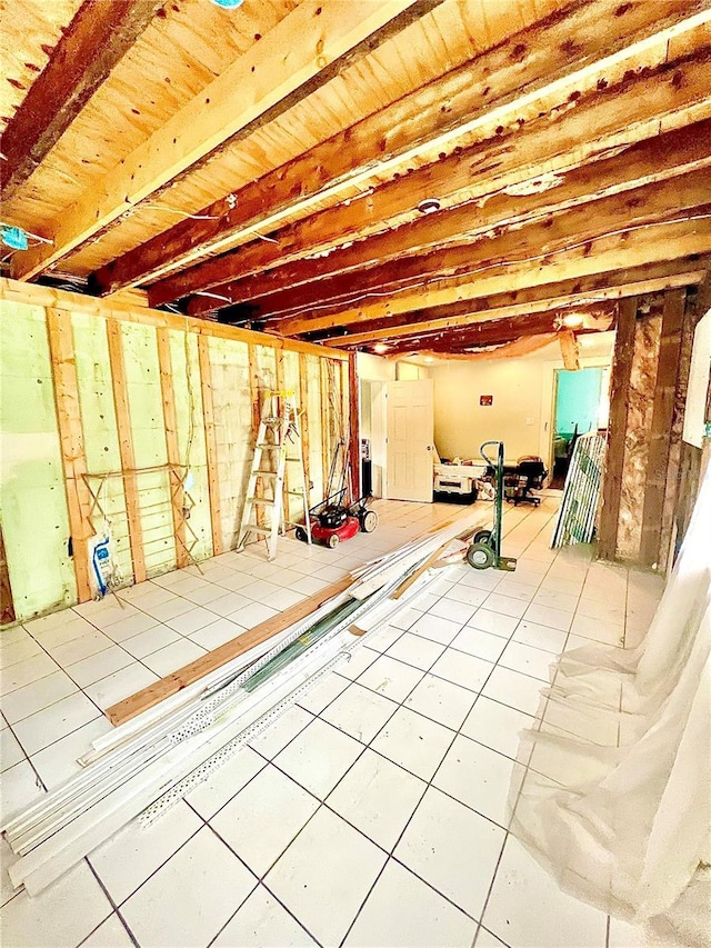 basement featuring tile patterned floors and wood ceiling