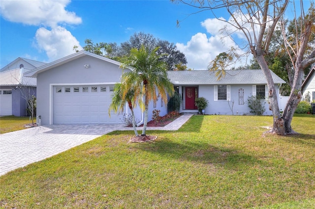 ranch-style house with a garage and a front yard