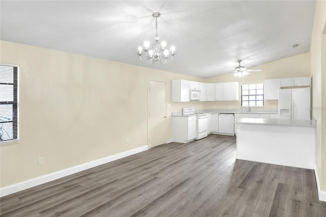 kitchen featuring white cabinetry, hanging light fixtures, white appliances, and wood-type flooring