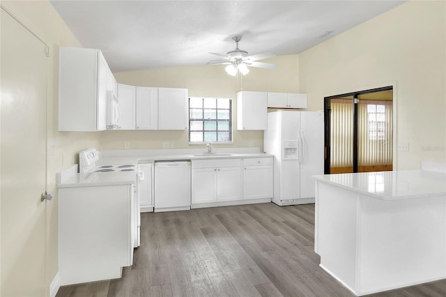 kitchen with white cabinetry, sink, white appliances, and lofted ceiling