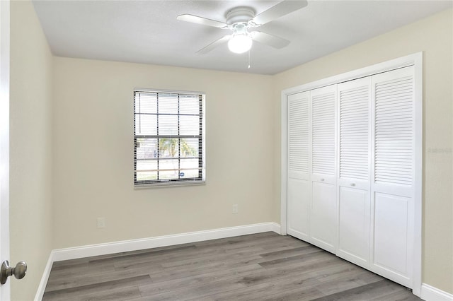 unfurnished bedroom with ceiling fan, light hardwood / wood-style floors, and a closet