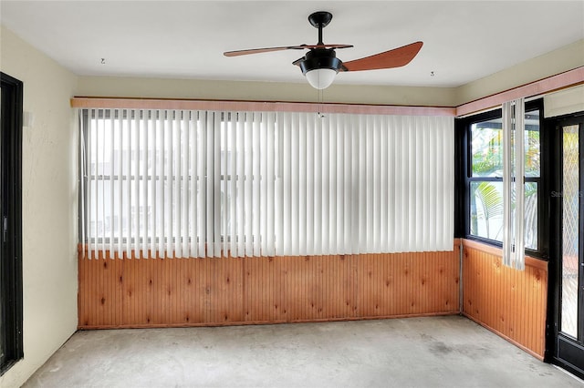 unfurnished sunroom with ceiling fan and a healthy amount of sunlight