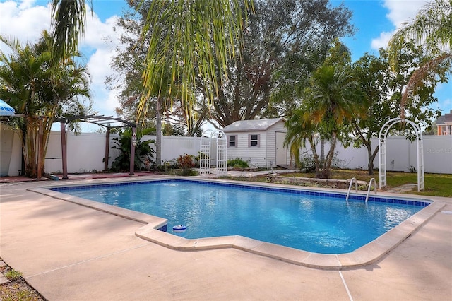 view of swimming pool with a pergola, a patio area, and a storage unit