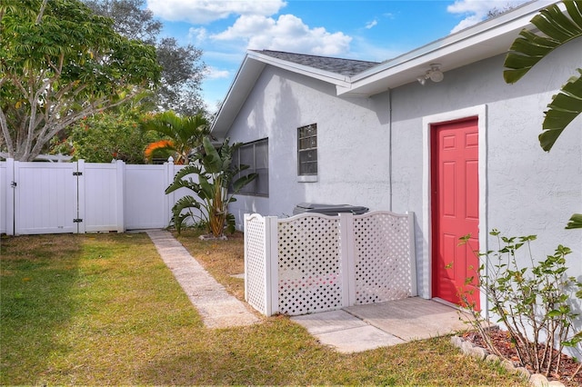 property entrance with a yard