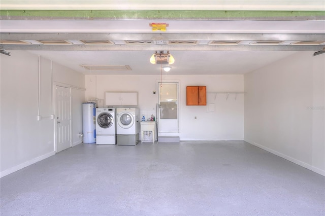 garage with a garage door opener, washing machine and dryer, and water heater