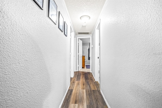 hall with dark hardwood / wood-style floors and a textured ceiling