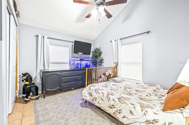 tiled bedroom with high vaulted ceiling and ceiling fan