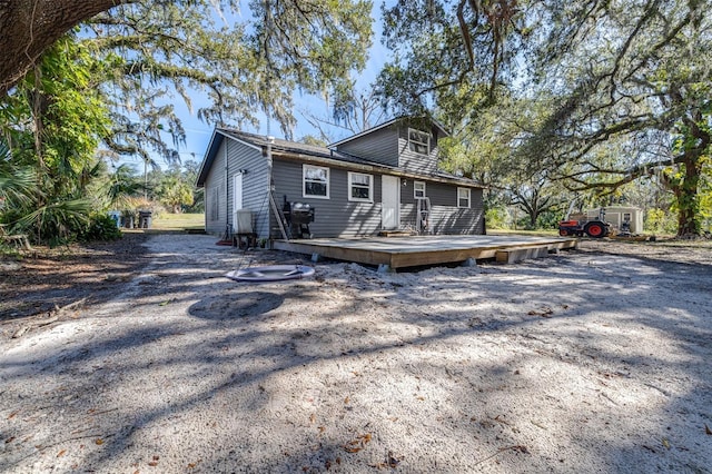 back of property with a wooden deck