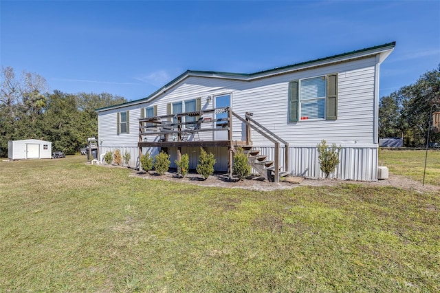 rear view of house with a wooden deck, a yard, and a shed