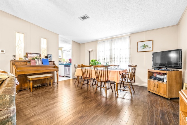 dining room with dark hardwood / wood-style flooring and a textured ceiling