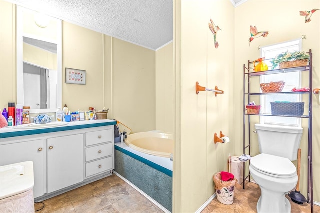 bathroom with vanity, a tub, toilet, and a textured ceiling