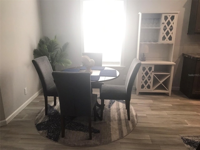 dining space with hardwood / wood-style floors