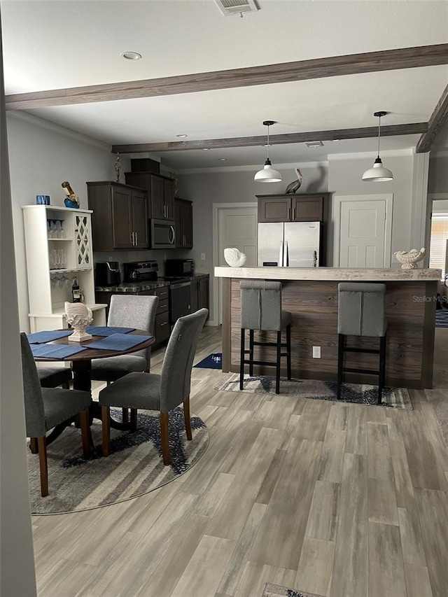 dining area featuring beamed ceiling