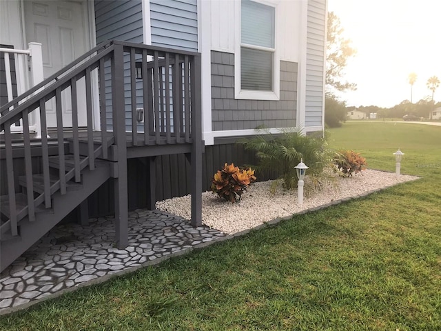 view of side of home with a yard