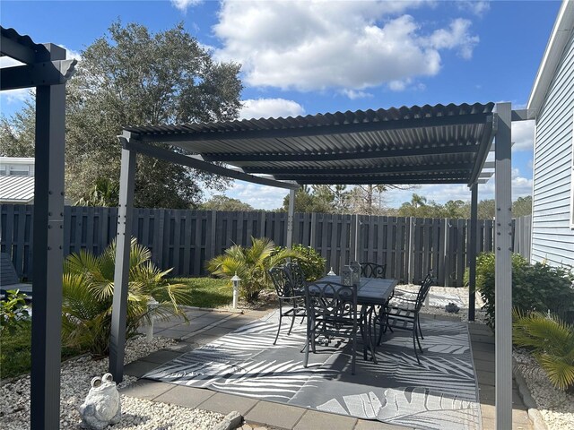 view of patio featuring a pergola, outdoor dining area, and fence