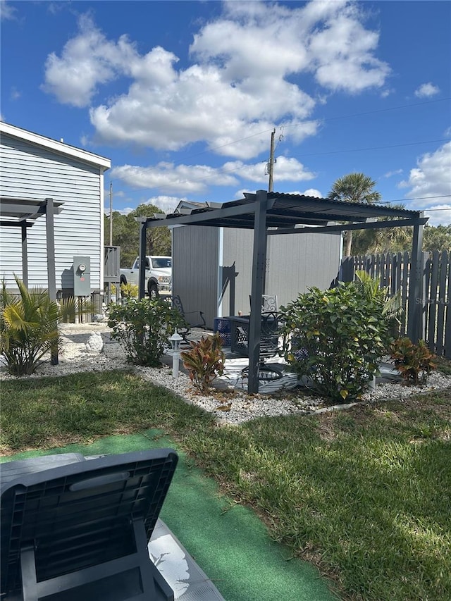 view of yard featuring a pergola, fence, and a patio area