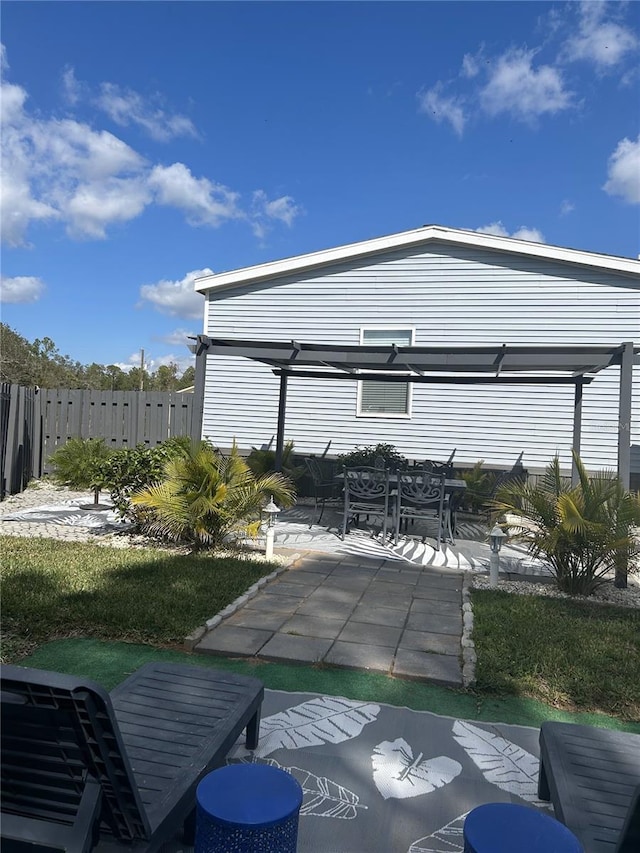 view of patio / terrace with outdoor dining area, a pergola, and fence