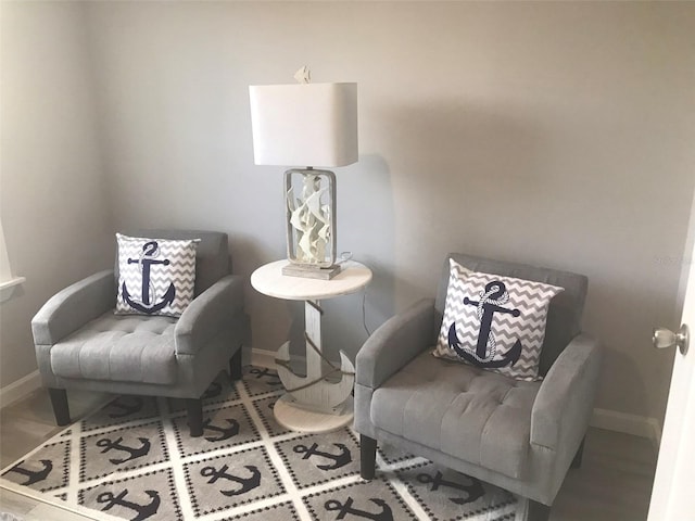 sitting room featuring baseboards and wood finished floors
