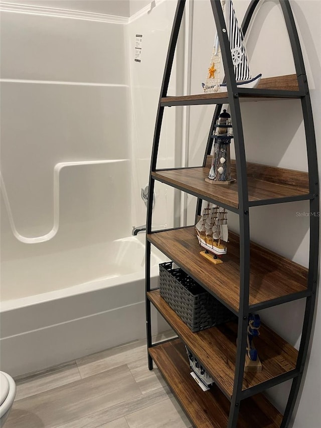 bathroom featuring toilet and tub / shower combination