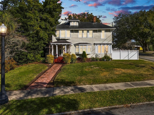 colonial home with a lawn