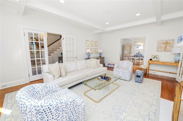 living room with beam ceiling and hardwood / wood-style floors